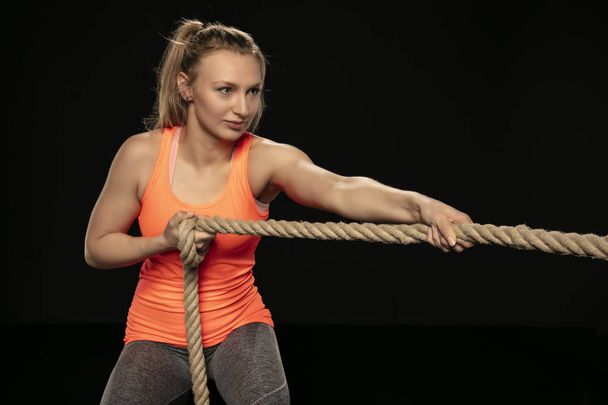 athletic girl exercising with a thick rope - Zdjęcie, obraz