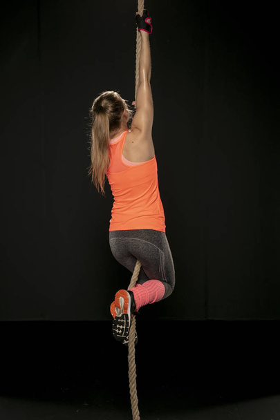 athletic girl exercising with a thick rope - Photo, image