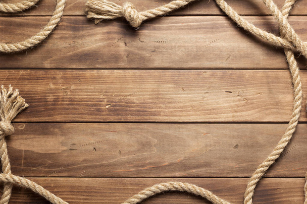 ship rope at wooden board background - Foto, imagen