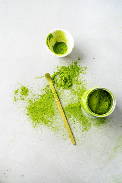 Bowl organic green tea Matcha powder with Chashaku spoon on light background - Foto, imagen