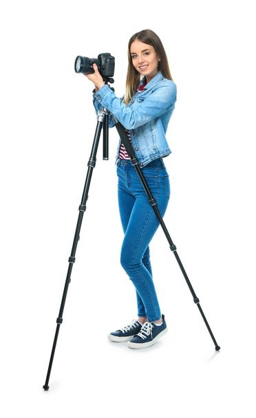 Young female photographer on white background - Foto, imagen