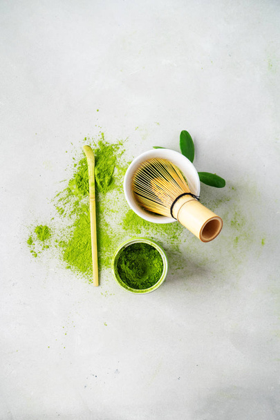 Organic green tea Matcha powder with chasen bamboo whisk, bowl for brewing on light background - Zdjęcie, obraz