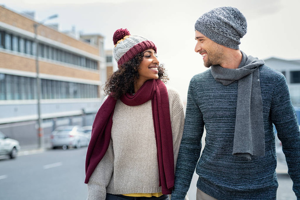 Multiethnic couple in love walking during winter - Valokuva, kuva
