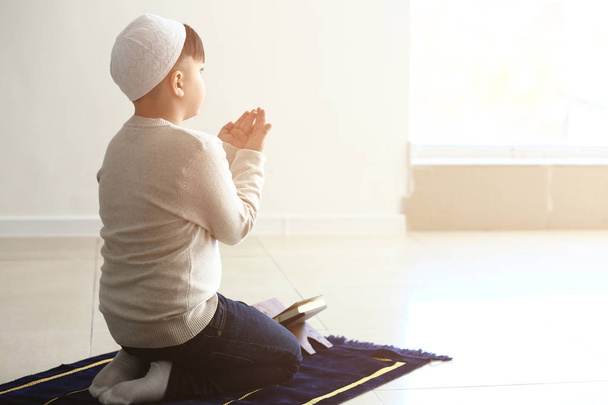Little Muslim boy praying indoors - Fotoğraf, Görsel