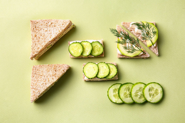 Tasty sandwiches with cucumber on color background - Photo, Image