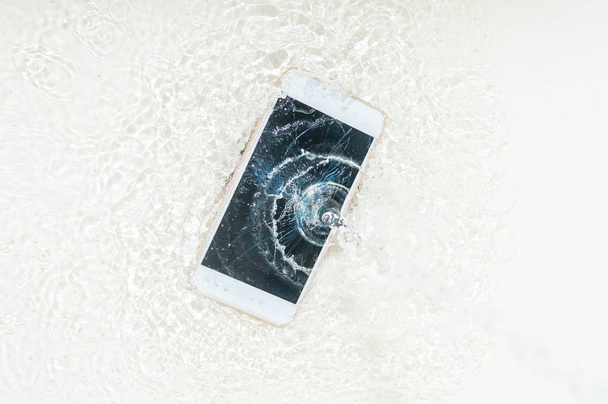 Phone in the water. Concept broken phone. Smartphone repair concept - Valokuva, kuva