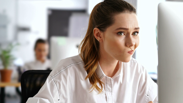 Young confused nervous woman working in office using pc computer - Footage, Video