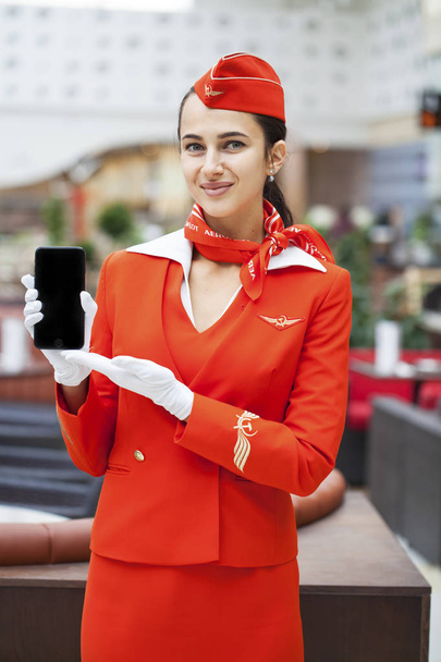 RUSSIA, MOSCOW: 28 JUNE 2019. Beautiful stewardess dressed in of - Photo, Image