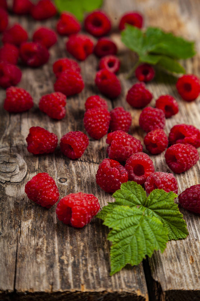 Ripe raspberry on an old wooden table. - Фото, изображение