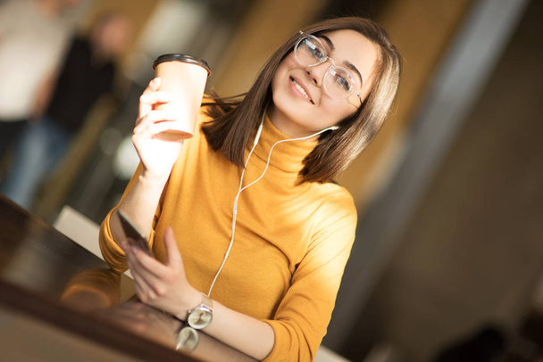 female blogger listening favorite songs in headphones , hipster girl enjoying radio broadcast making photo for picture in social networks on mobile - Photo, Image