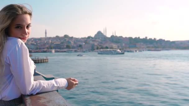 Pomalý pohyb: krásná dívka stojí nad mostem Galata a těší se pohledu na Bospor v Istanbulu v Turecku. koncepce cestovatele - Záběry, video
