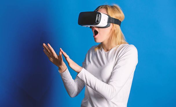 Woman with glasses of virtual reality. 3d technology, virtual reality, entertainment, cyberspace and people concept - young woman with virtual reality headset or 3d glasses. Woman using VR device. - Foto, afbeelding