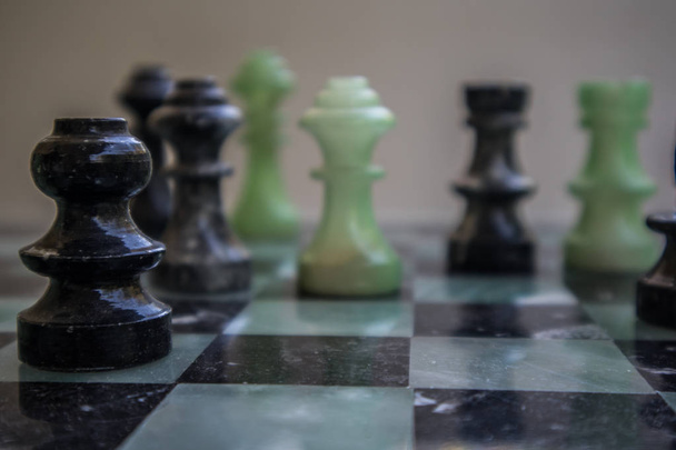 Chess pieces on a marble chessboard  - Photo, Image