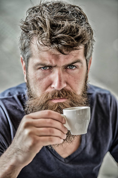 Espresso arabica only. Coffee break concept. Guy relaxing espresso. Enjoy hot drink. Hipster drinking fresh brewed coffee. Man with beard and mustache and espresso cup. Bearded guy consume caffeine - Photo, Image