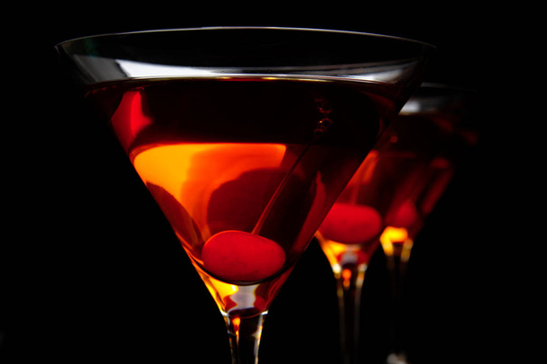 Close-up manhattan drinks with red cherry on black table - Foto, imagen