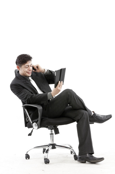 Portrait of a businessman sitting with digital tablet - Fotoğraf, Görsel