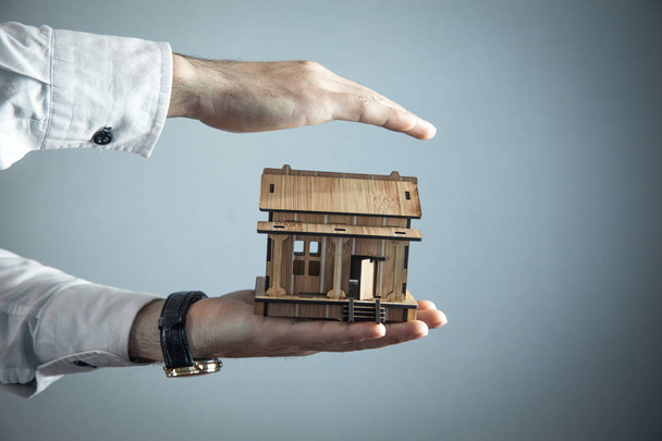 Real estate agent protect wooden house.  - Valokuva, kuva