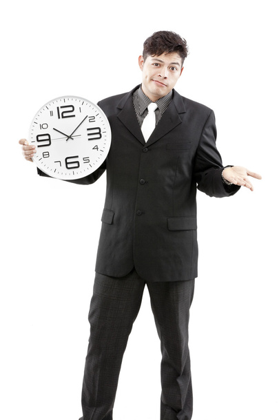 Conceito de tempo, Empresário segurando relógio grande e dar a expressão em seu rosto
 - Foto, Imagem