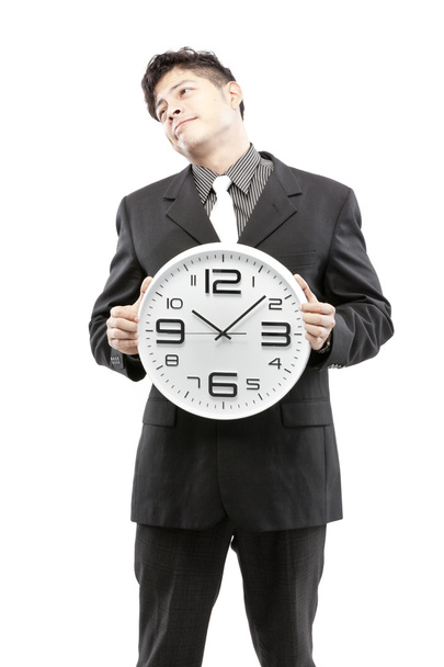 Концепція часу, бізнесмен тримає великий годинник і дає вираз на обличчі
 - Фото, зображення