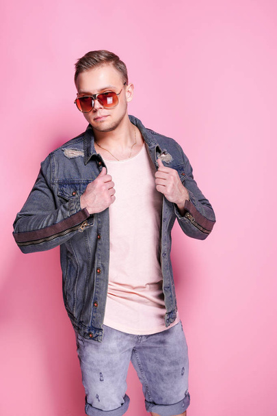 Confident stylish casual guy posing on pink - 写真・画像