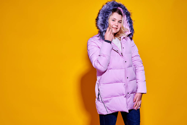 Young fashion woman in short violet down jacket. - Foto, Bild