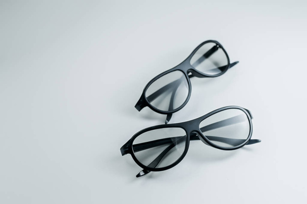 Két pár 3D-s szemüveg a mozi. Filmnézés 3D-ben. Fekete szemüvegek. - Fotó, kép