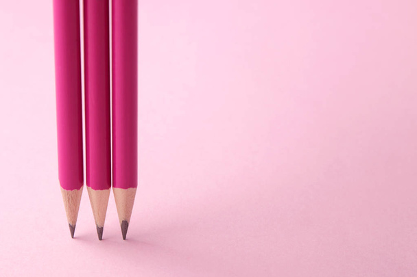 composition with pink pencil on a bright trendy pink background. top view. space for text - Fotoğraf, Görsel