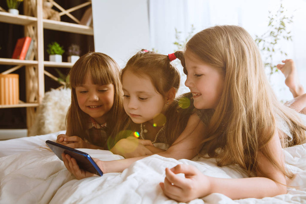 Little girls using different gadgets at home - Fotografie, Obrázek