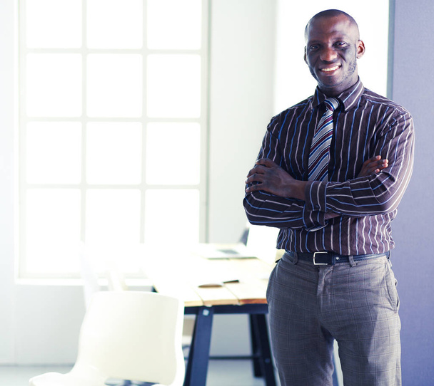 Portrait of an handsome black businessman standing in office - Photo, Image