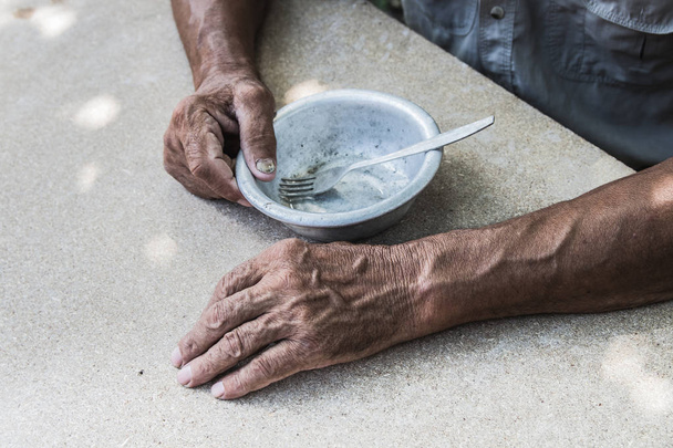 Hungry. Poor old man's hands an empty bowl. Selective focus. Pov - Photo, Image
