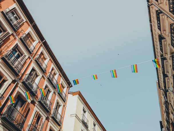 rainbow LGBT flag against blue sky in Madrid city - Photo, image