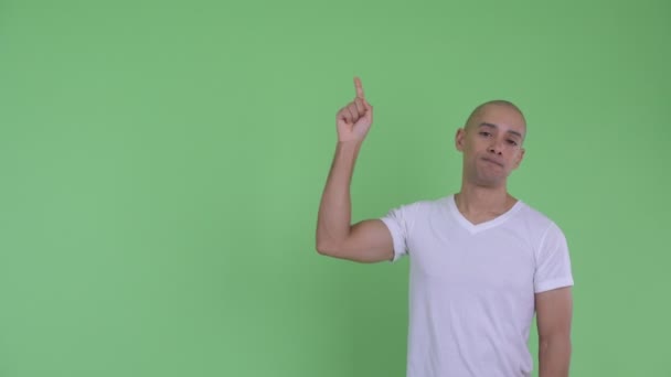 Stressed bald man pointing up and giving thumbs down - Footage, Video