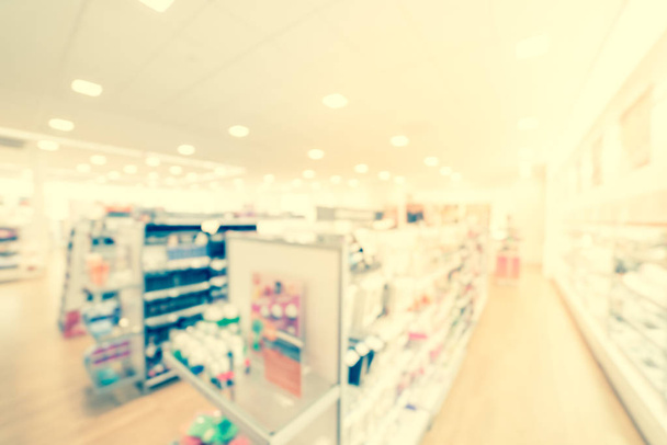Filtered image blurry background cosmetics and makeup supplies at American beauty store - Photo, Image