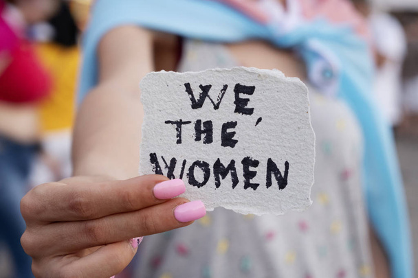 woman showing a note with the text we the wome - Photo, Image