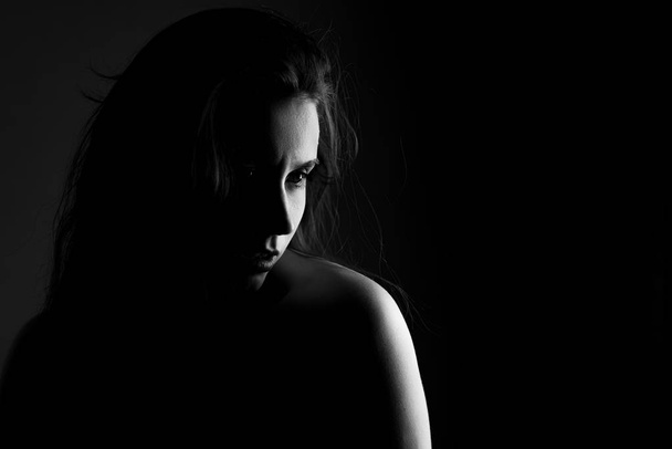 Portrait of a girl in black and white on black background in noir style - Zdjęcie, obraz