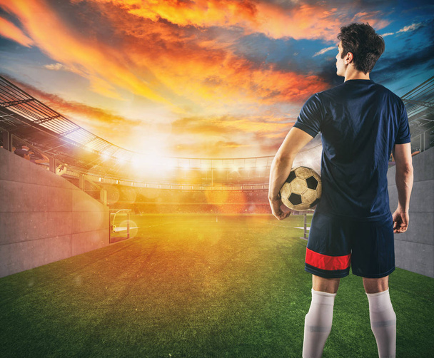 Jogador de futebol pronto para jogar com bola em suas mãos na saída do túnel do vestiário
 - Foto, Imagem