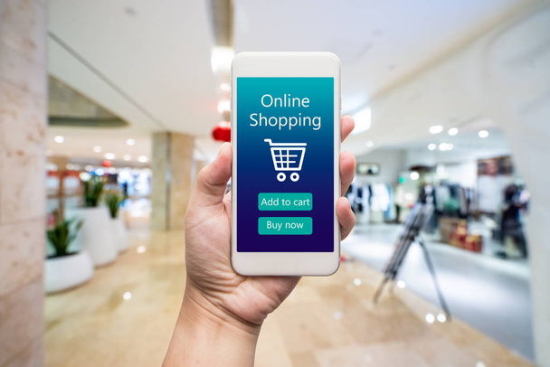 Smart phone online shopping in woman hand. Shopping center in ba - Fotó, kép