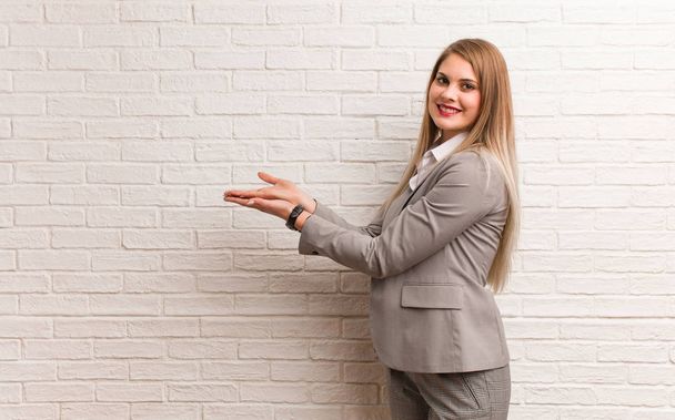 Young russian business woman holding something with hand - Photo, image