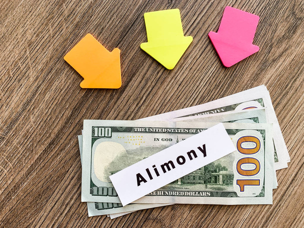 Payments alimony. Pile Dollars with sign alimony and money. Divorce and separation concept. - Photo, Image