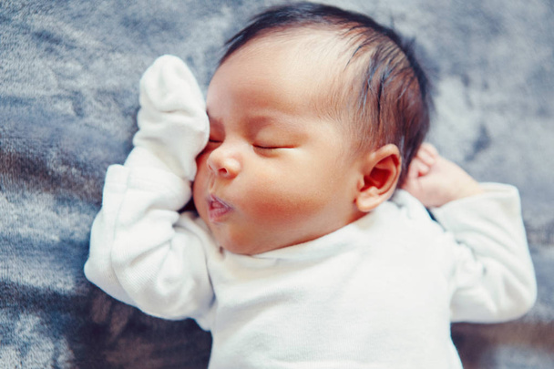 Closeup portrait of cute adorable sleeping Asian Chinese mixed race newborn baby girl boy lying on bed in bedroom. Healthy happy childhood ethnic diversity lifestyle. - Zdjęcie, obraz