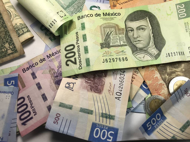 Mnoho smíšených mexických Peso se rozprostřel na dřevěném stole - Fotografie, Obrázek