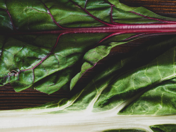 Raw mangold on wooden backgound, Fresh leaves of chard, close up - Photo, Image