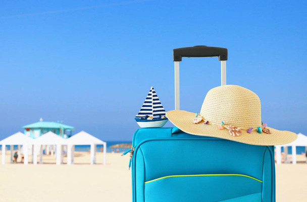 holidays. travel concept. blue suitcase infront of tropical background - Fotoğraf, Görsel