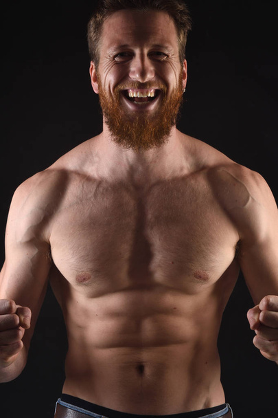 angry shirtless man in black background - Foto, immagini
