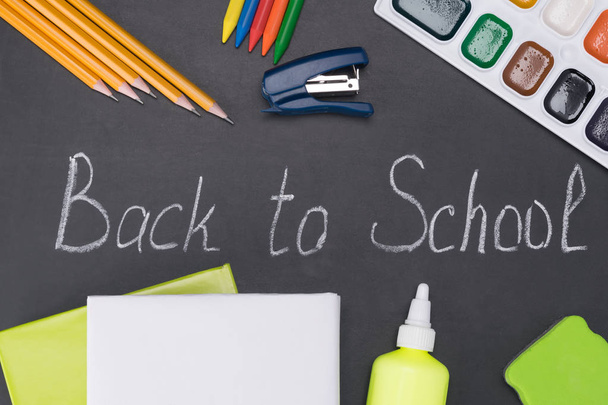set of school supplies on the background of a chalk board with the inscription - Fotoğraf, Görsel