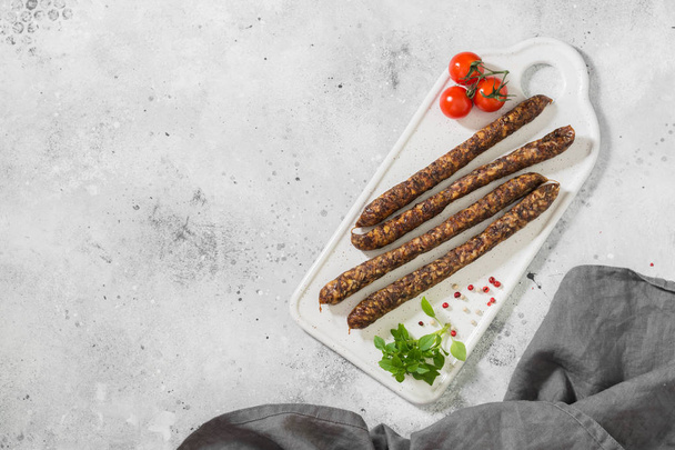 Smoked sausages on a wooden Board. Sausages to beer. Light background - Фото, зображення