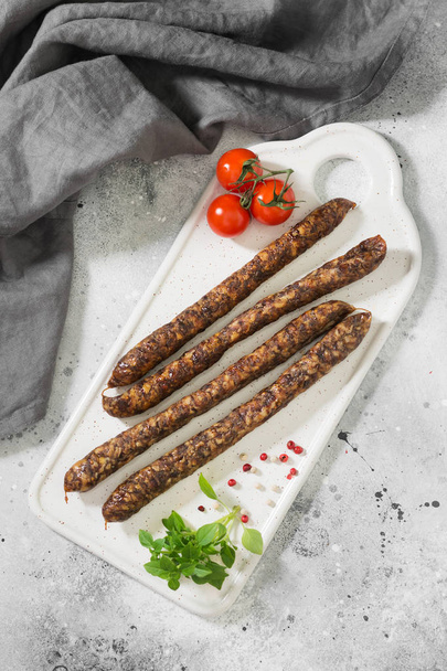 Smoked sausages on a wooden Board. Sausages to beer. Light background - Фото, зображення