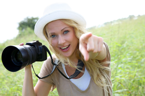 Portrait of adventure girl using photo camera in nature - Photo, image