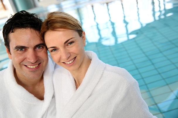 Portrait of couple in bathrobe standing in spa center - Фото, изображение