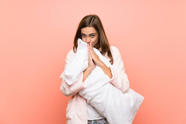 Young woman in dressing gown over pink wall pleading - Фото, изображение